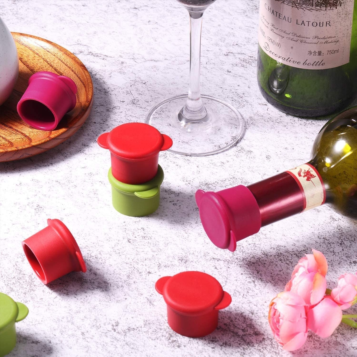 Several wine caps next to a bottle with a cap on it