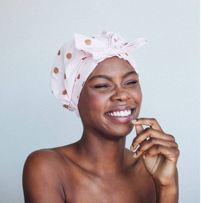 An image of a model wearing a elevated shower cap with a polka dot print
