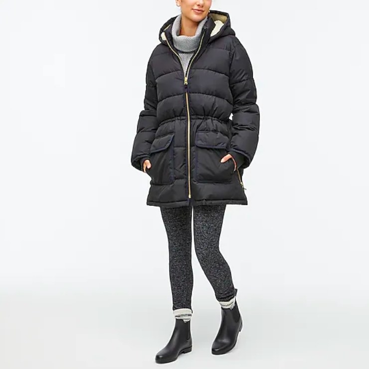 Model wearing black puffer coat, gray turtleneck, gray leggings and black boots