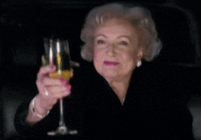 Betty White cheering to toast. 