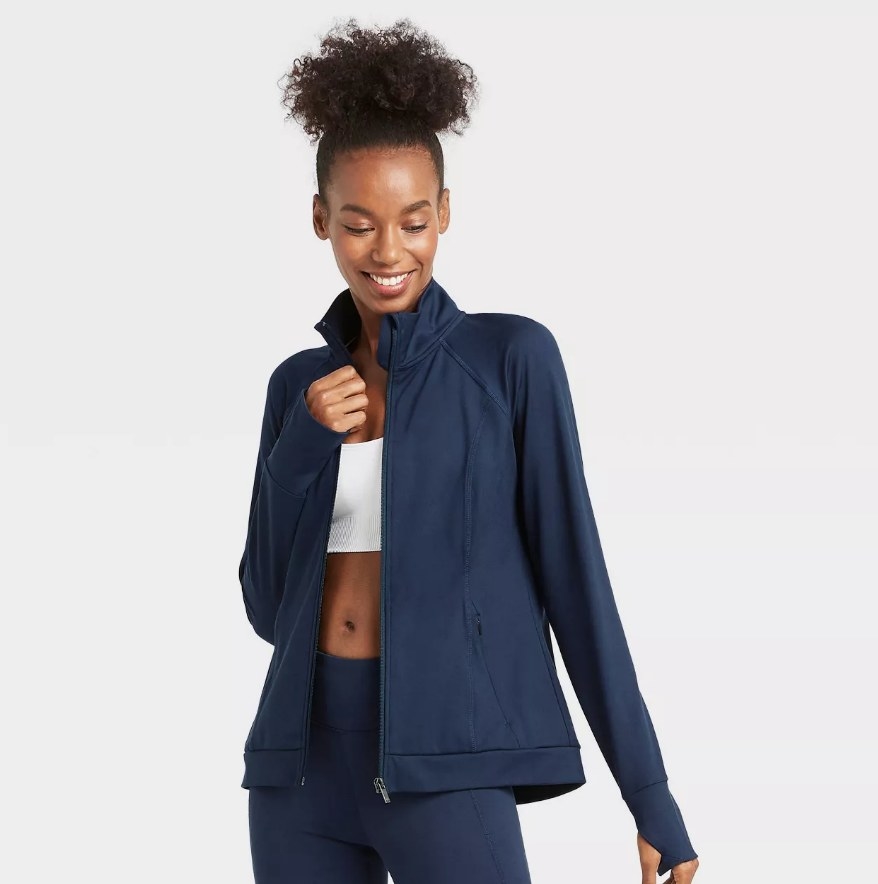 A model wearing a zip-front jacket in navy