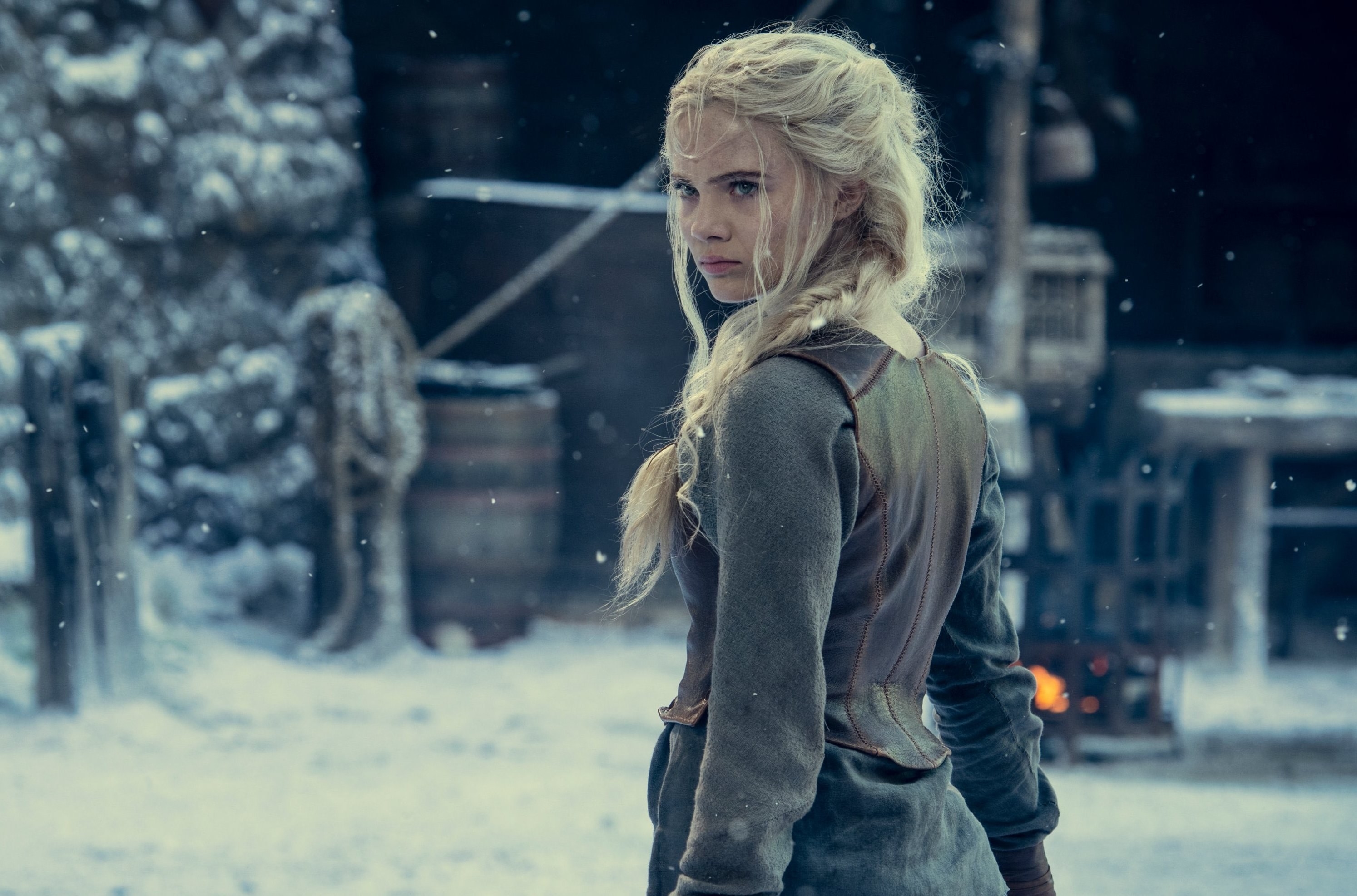 ciri from the show witcher looking back while standing outside in the snow