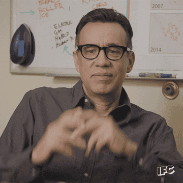 Fred Armisen plugs his ears with his fingers in