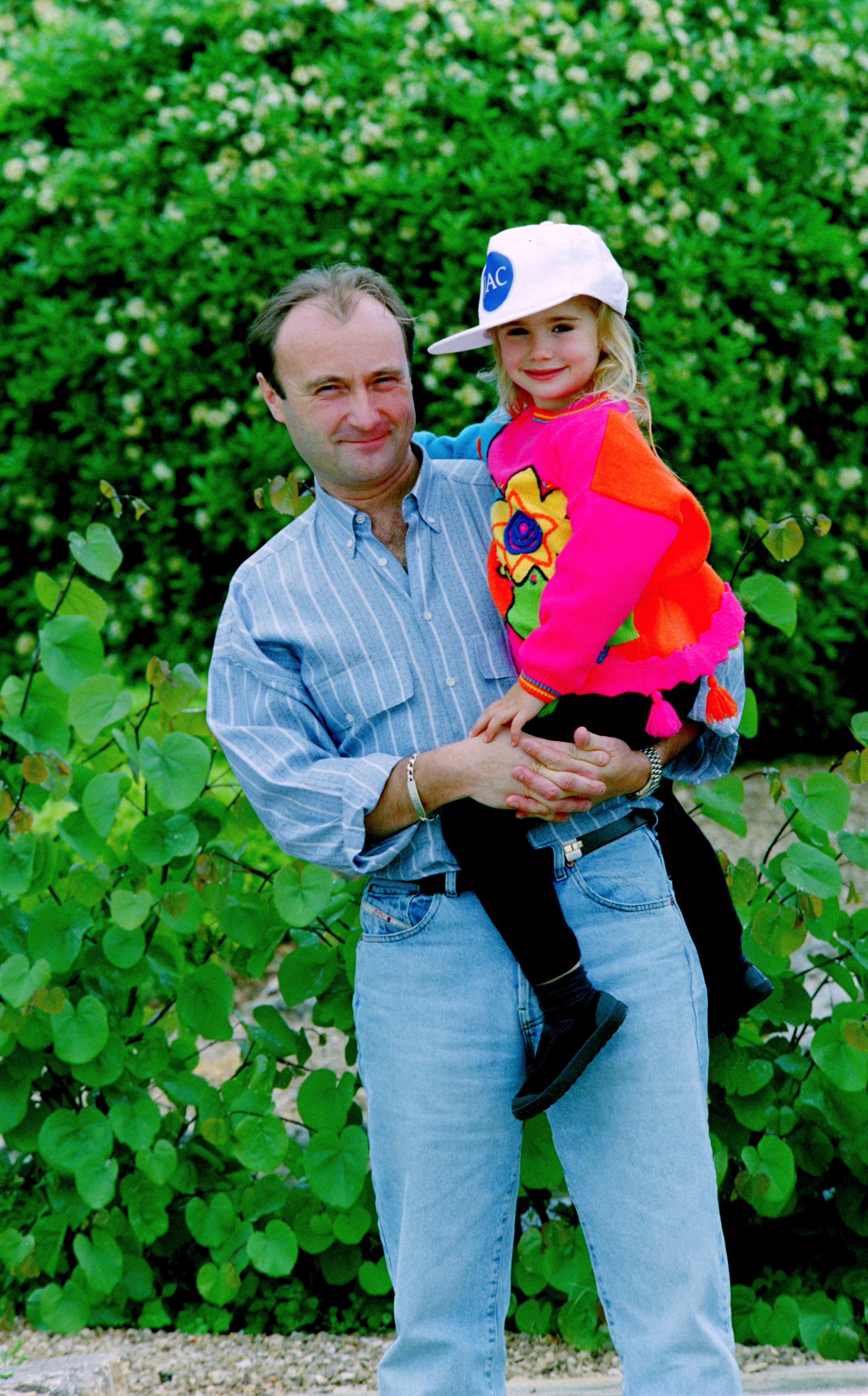 Phil Collins posing with his daughter Lily Collins