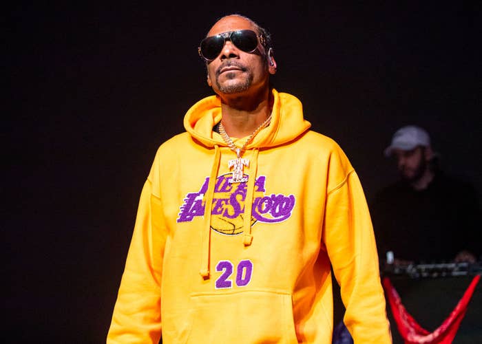 Snoop in a yellow Lakers hoodie