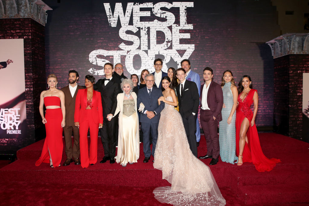 The cast of &quot;West Side Story&quot; featuring Ariana DeBose, Ansel Elgort, Rita Moreno, Steven Spielberg, Rachel Zegler, Maddie Ziegler, and others posing for a photo