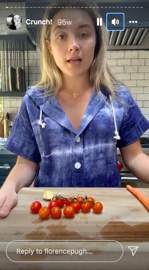 Florence Pugh in her kitchen with cutting board and tomatoes
