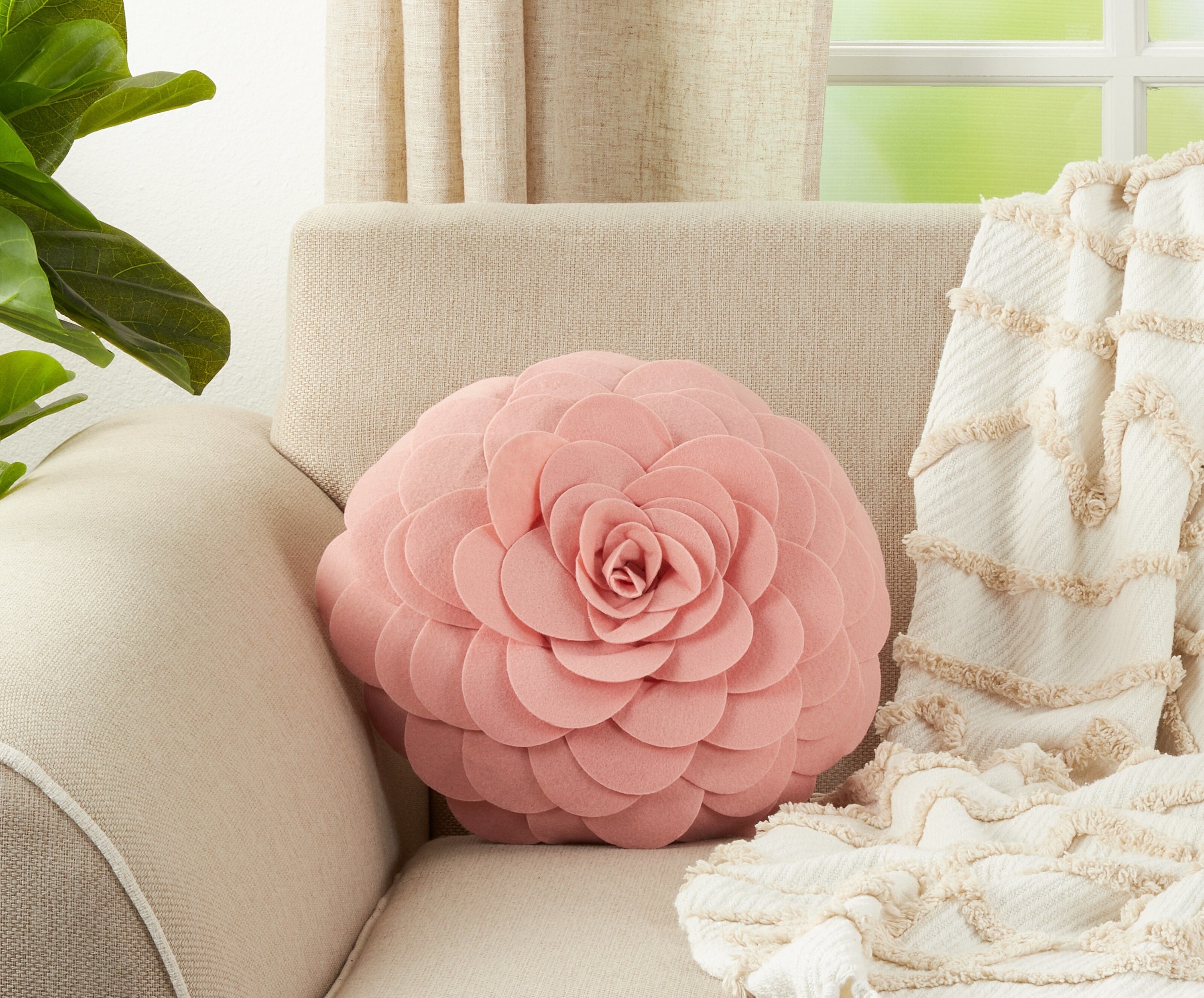 Pink rose floral throw pillow on couch