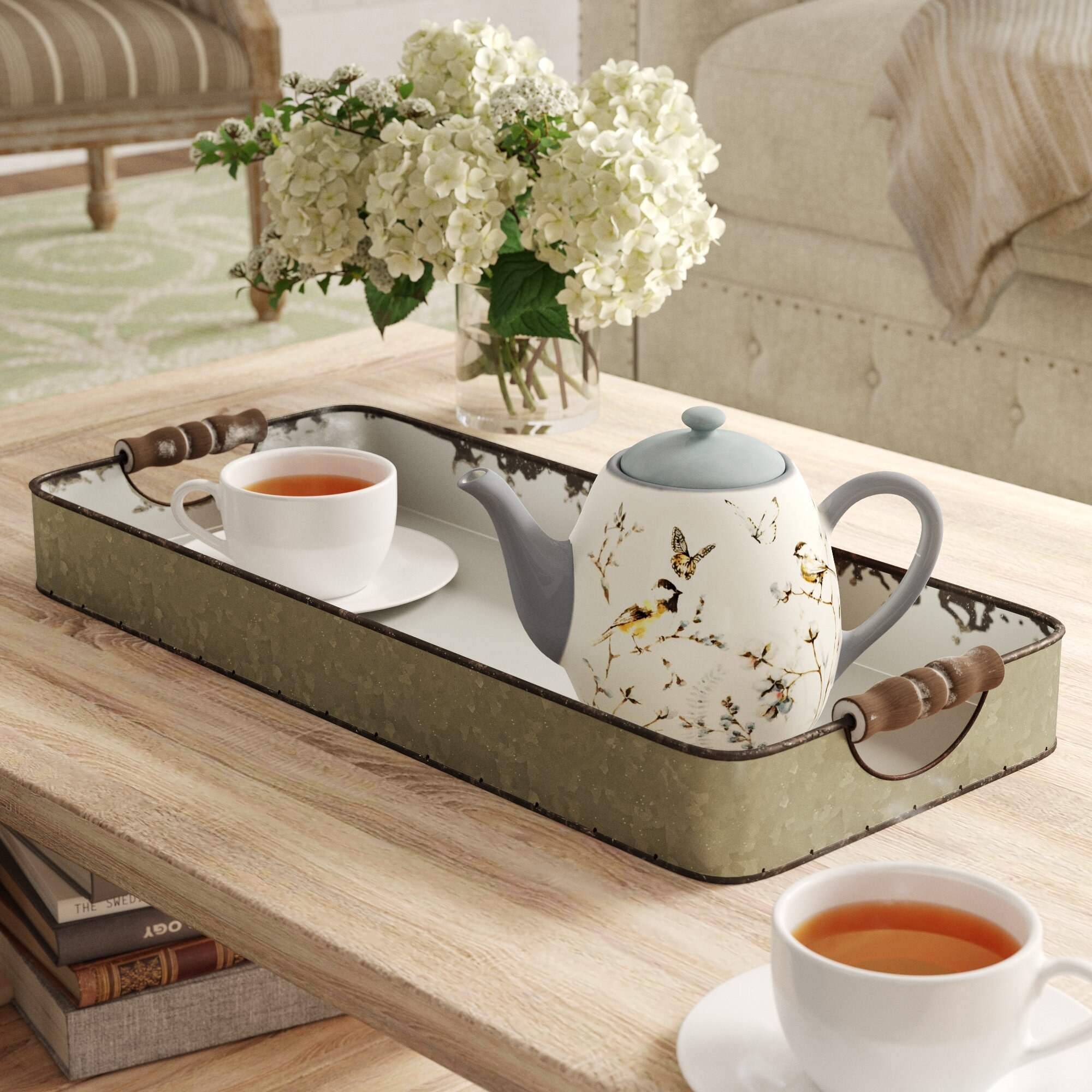 Coffee tray table with floral tea pot and cup of tea