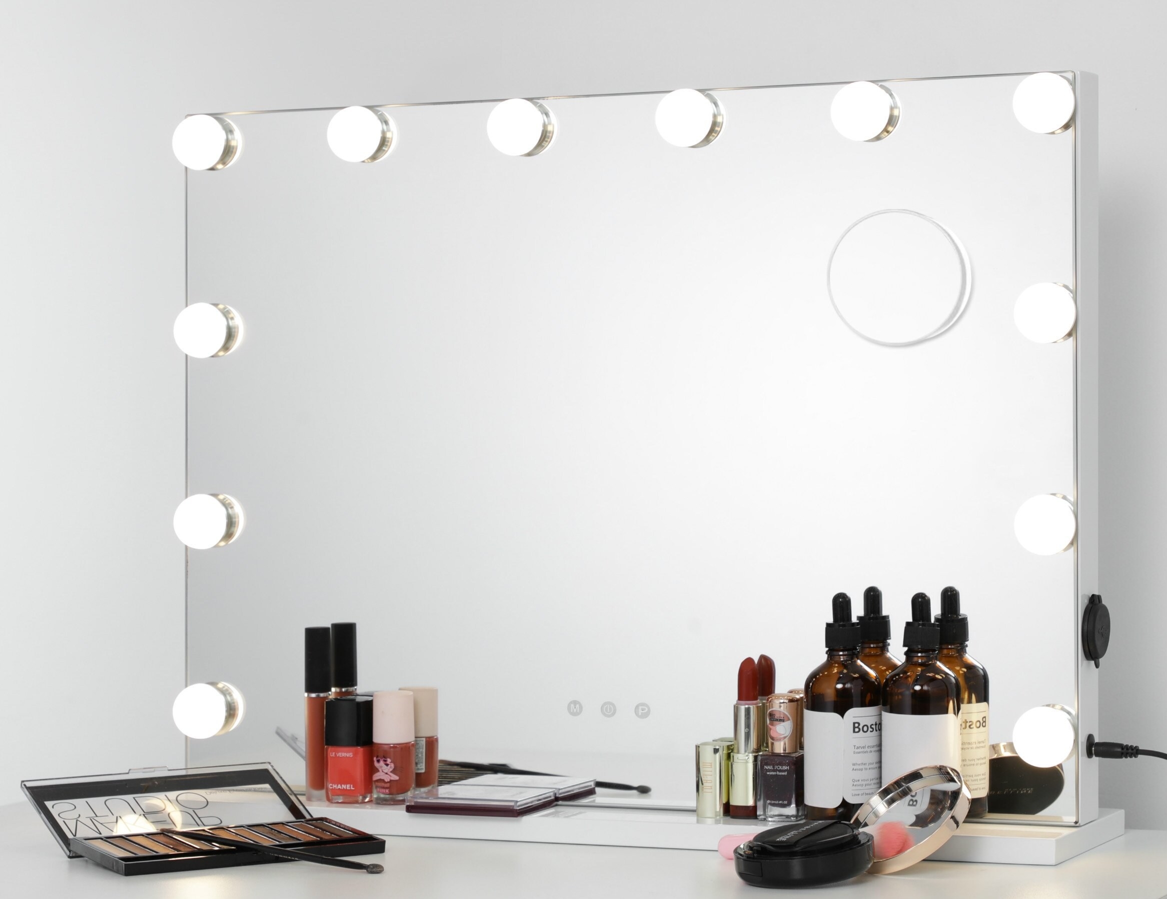 A lighted vanity mirror against a wall