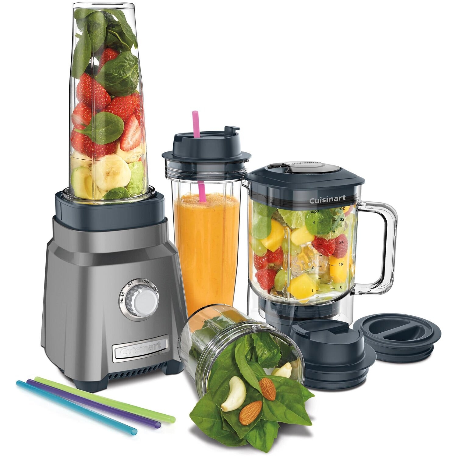 A Cuisinart blender with spinach and nuts next to straws
