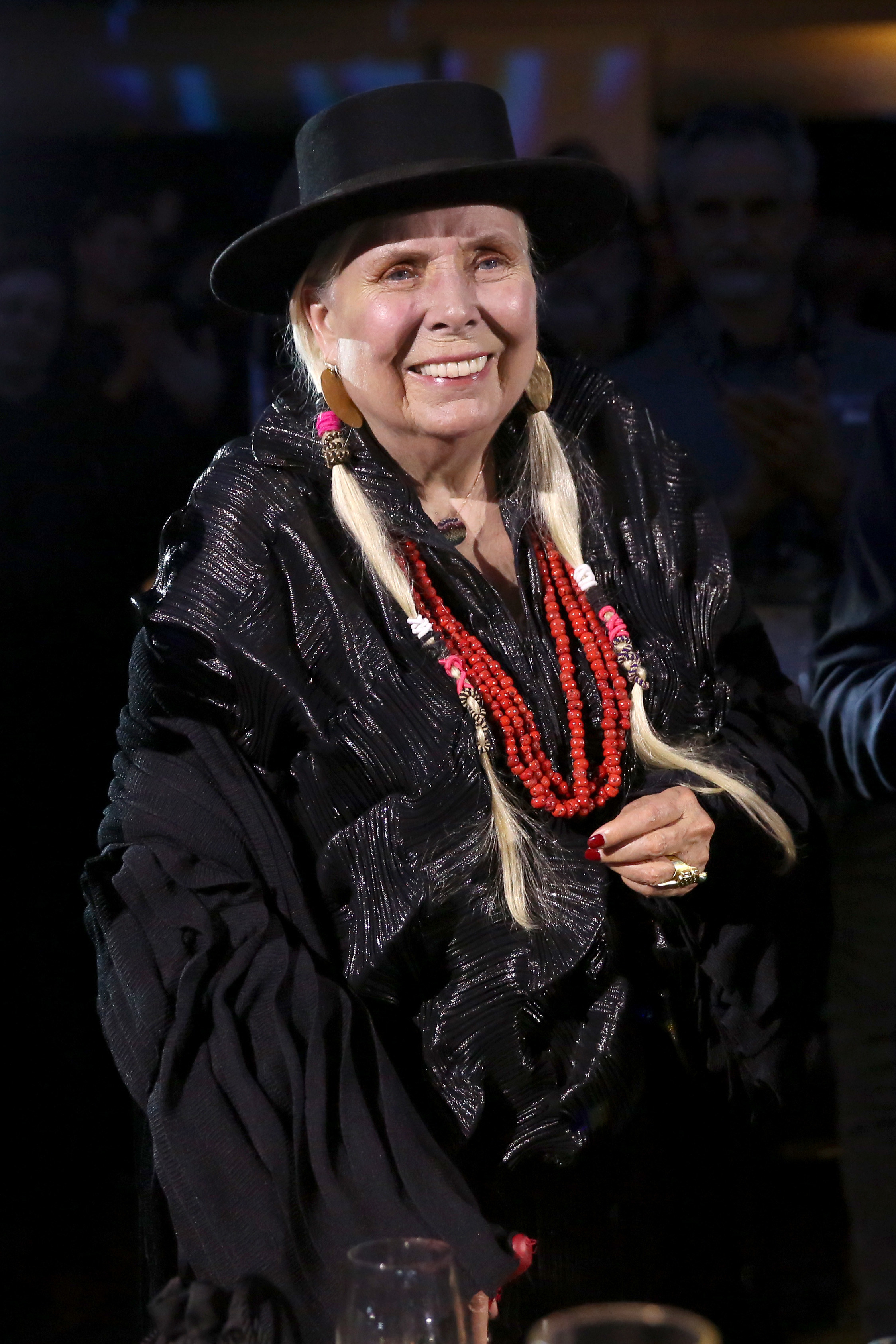 Joni Mitchell smiles at an event
