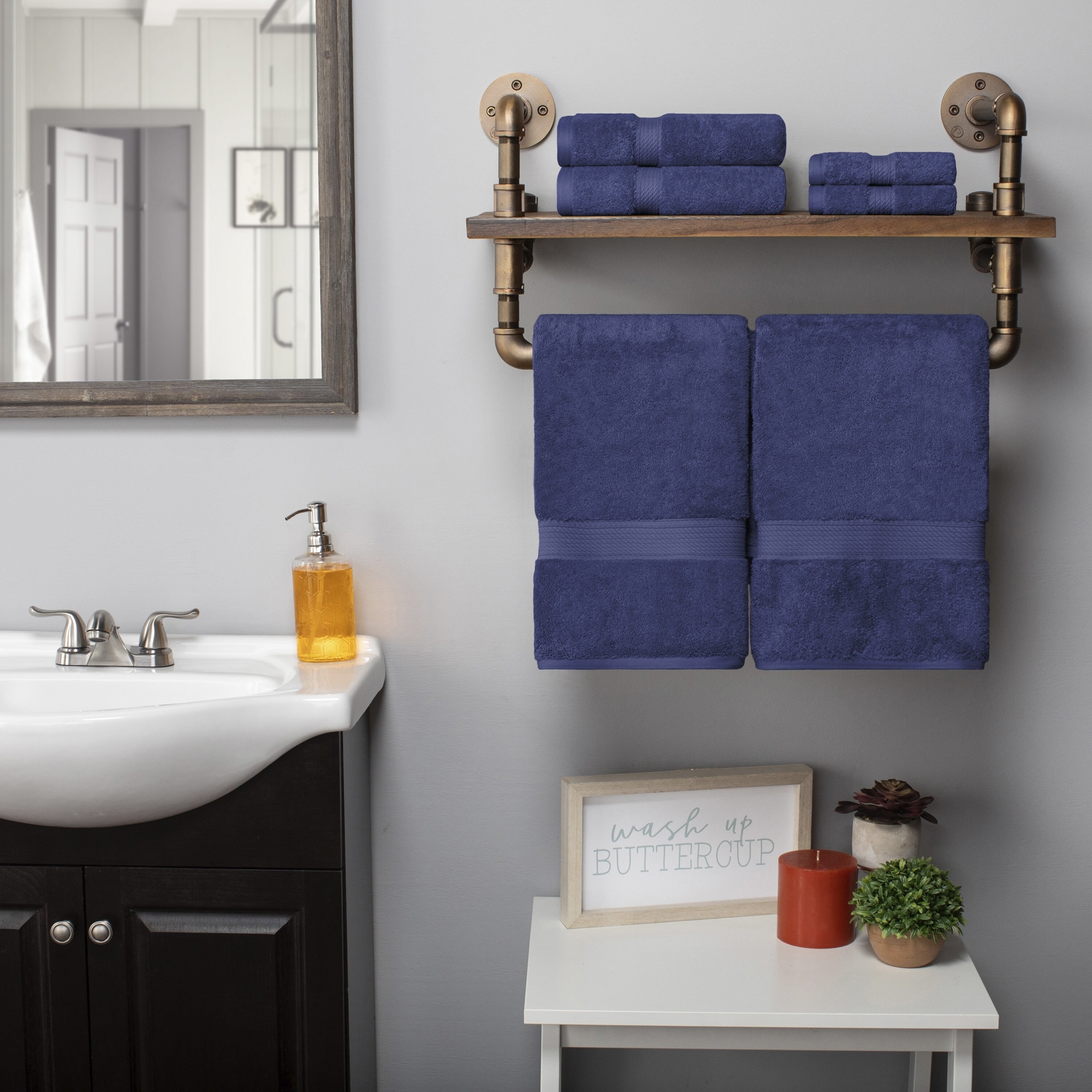 Navy blue towel set on rack in bathroom