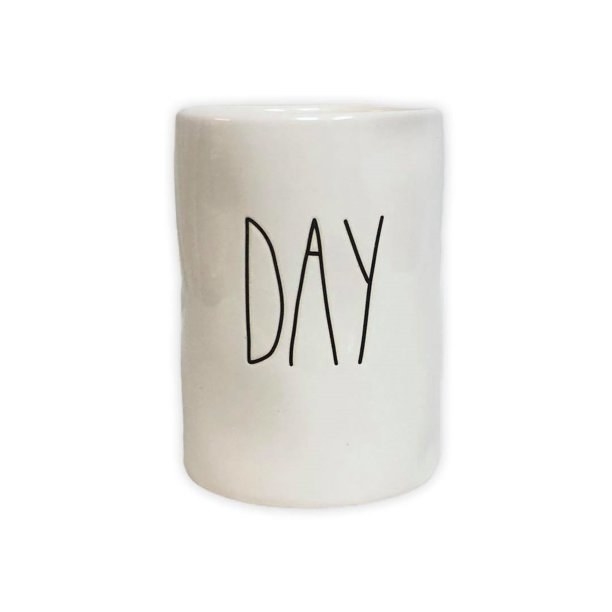 White Rae Dunn candle with "day" written on the jar