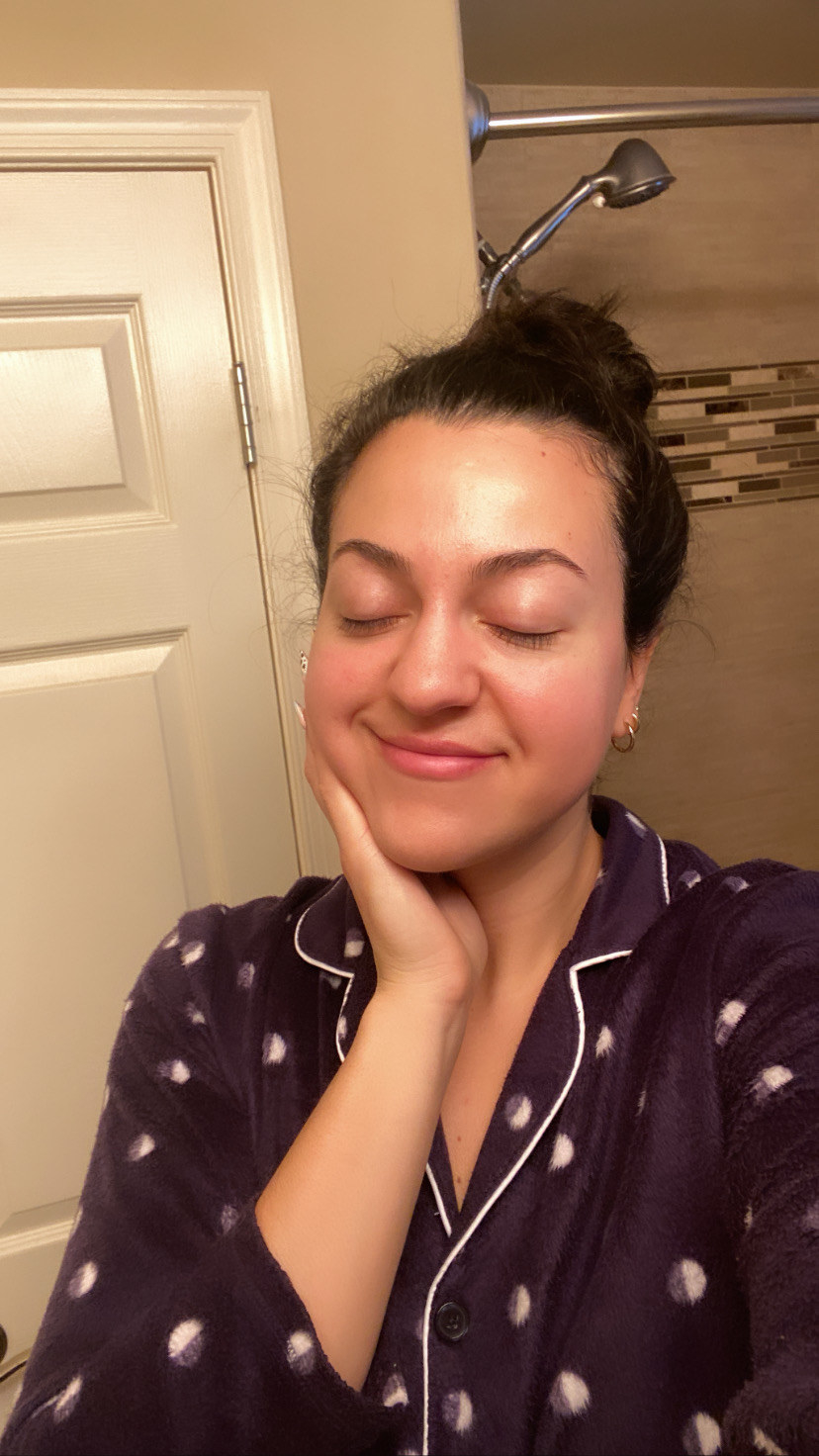 The author in polka dot pajamas smiling after removing her makeup