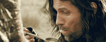 Aragorn sloppily sucking up some blobby mess of a stew that Éowyn gave gim.