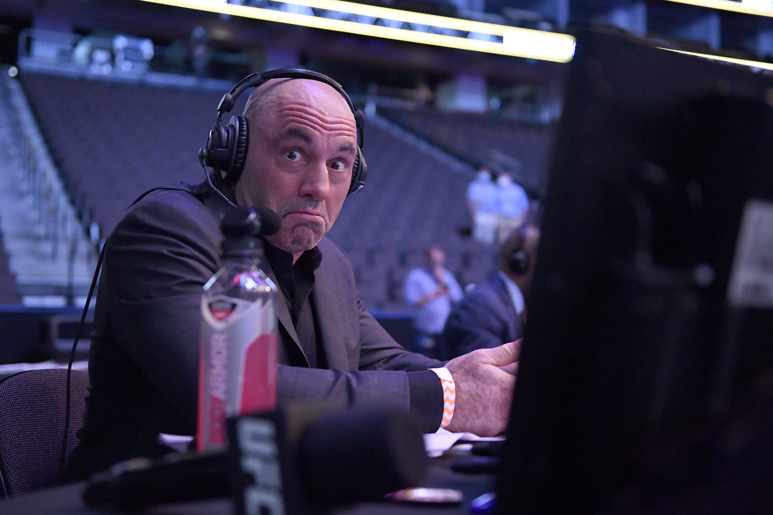 Joe Rogan wearing a headset and looking into the camera
