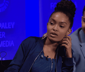 Yara Shahidi blows air out of her mouth and rolls her eyes at a Paleyfest event
