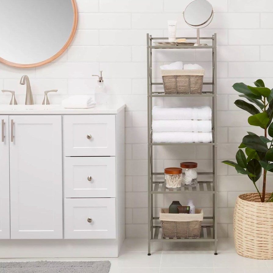 Shelf shown in a bathroom, filled with various bathroom accessories