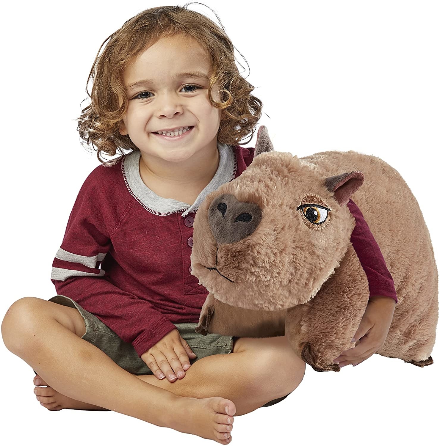 a child cuddling with the capybara pillow pet