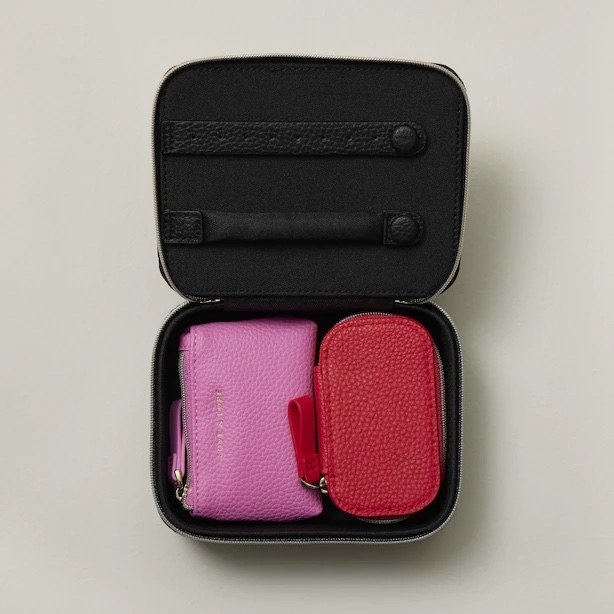 The vegan leather zip-up jewelry case opened revealing extra pouches inside