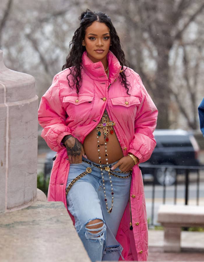 Rihanna walking outside showing off her bare belly bump