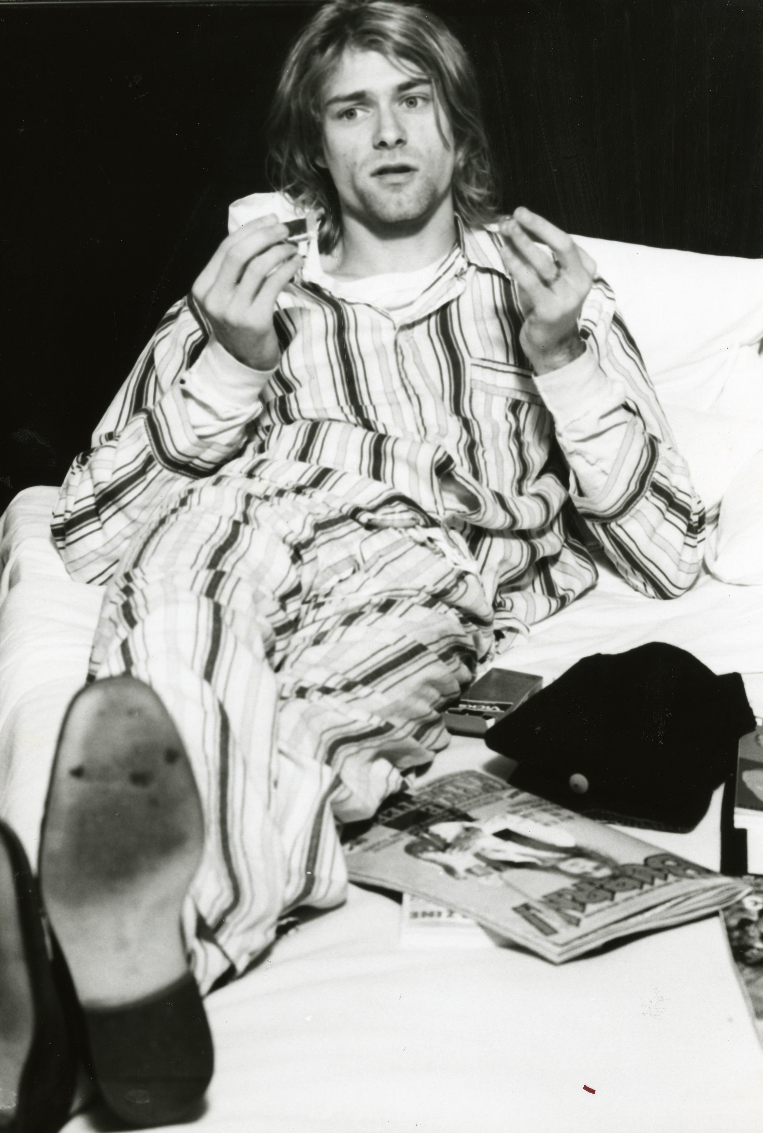 Kurt Cobain of Nirvana, lying in bed wearing pyjamas in Roppongi Prince Hotel in Tokyo, Japan 1992