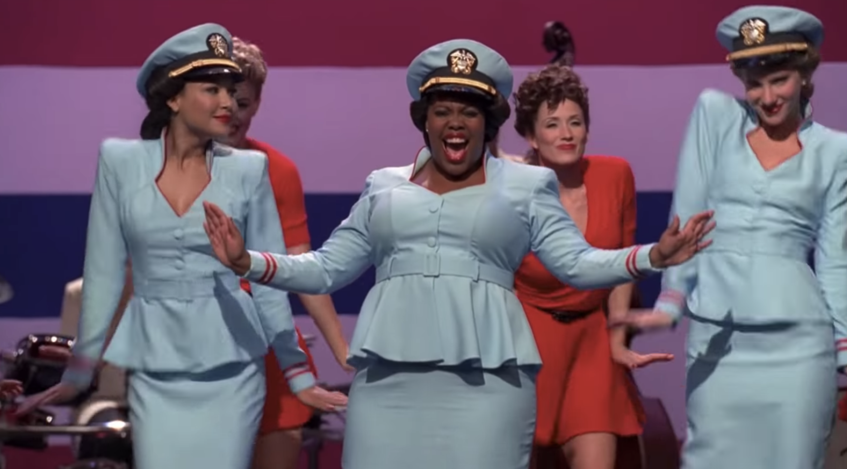 Mercedes, Santana, and Brittany wearing matching sailor costumes and singing on stage