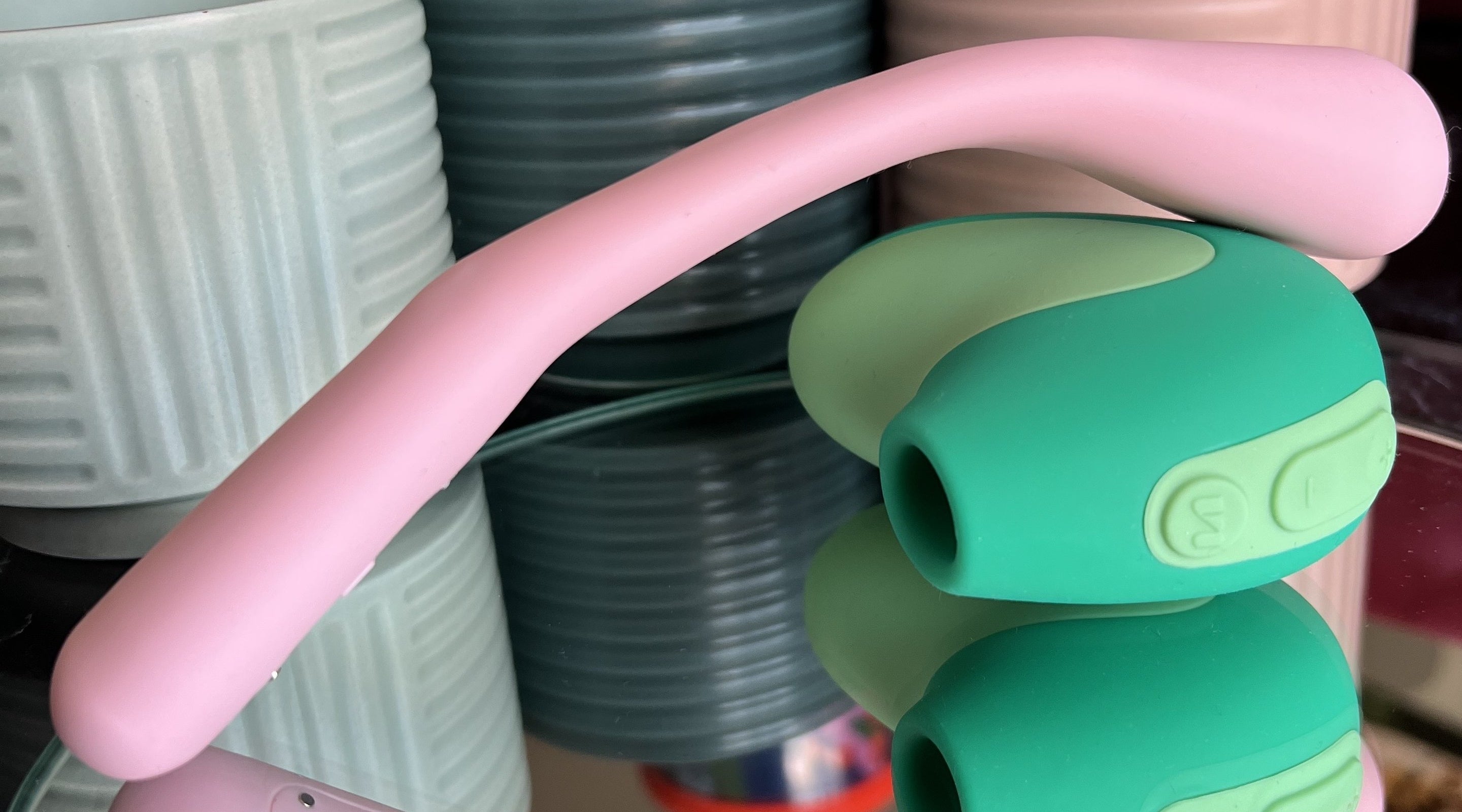 Pink flexible vibrator on green suction vibrator