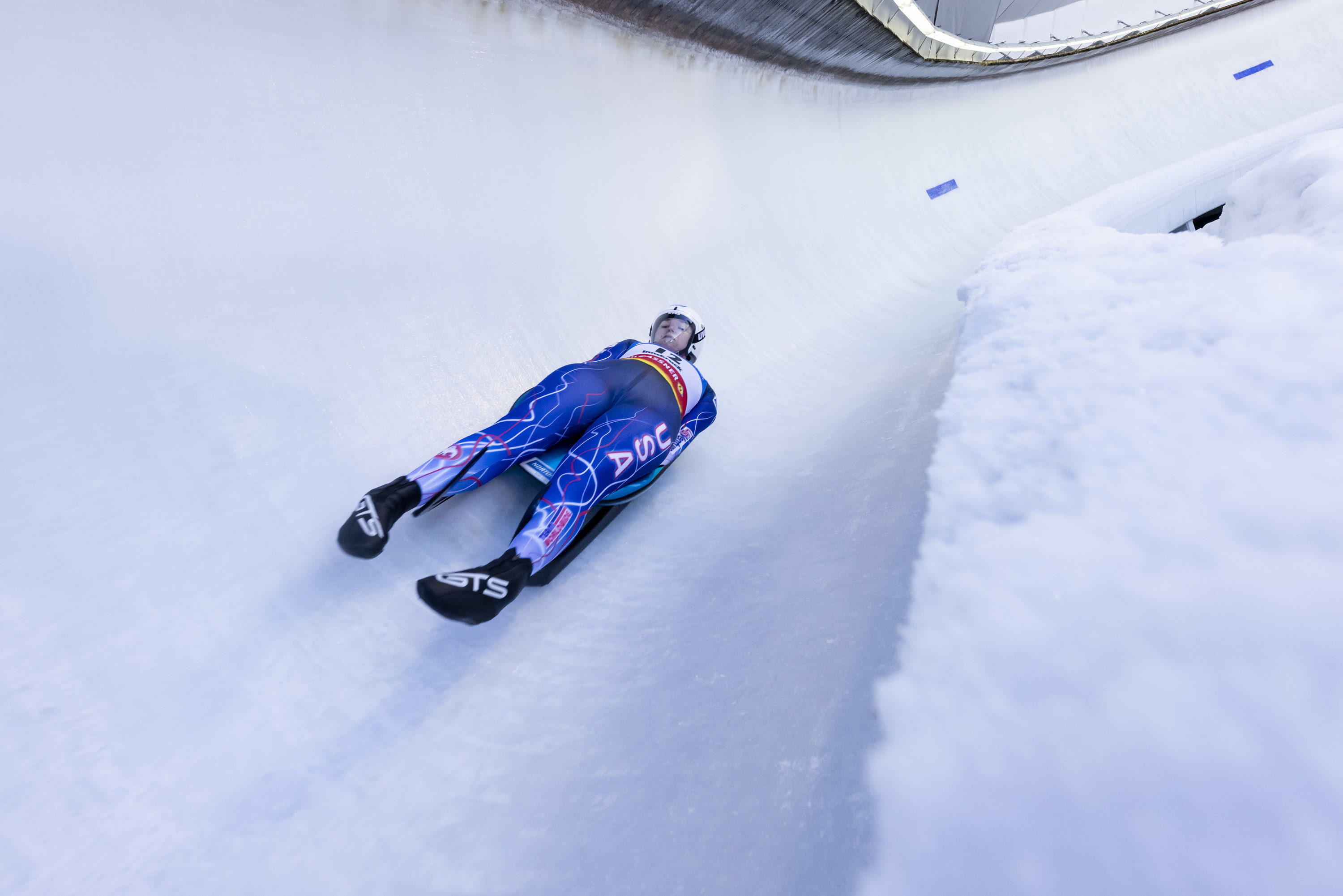 A female athlete competing in the luge at the Olympics