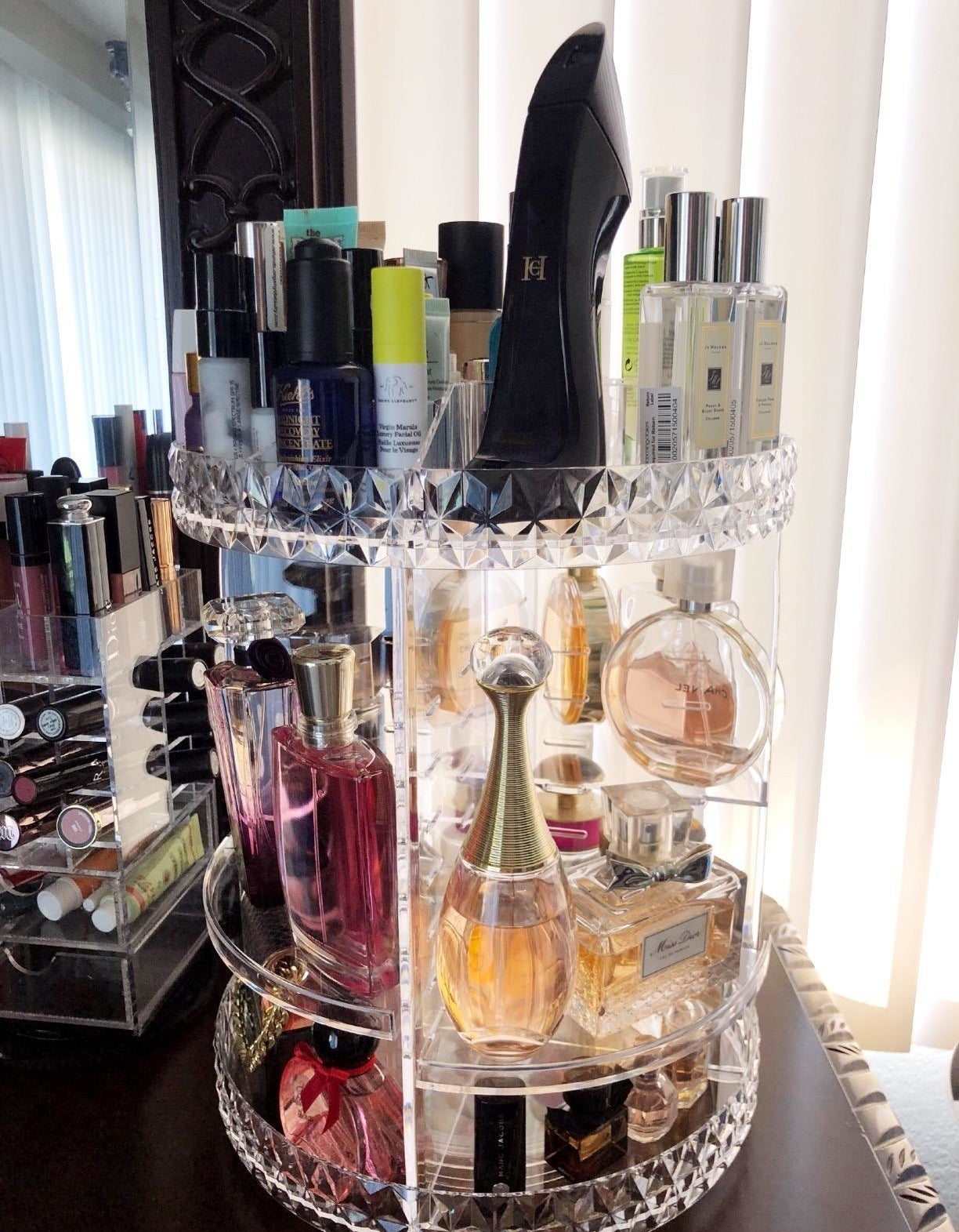 the three-tier makeup holder filled with perfume and makeup