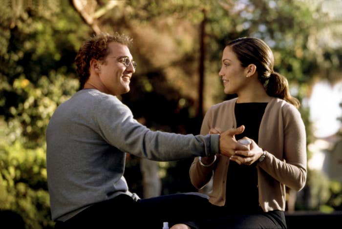 Matthew McConaughey and Jennifer Lopez sit together in the park