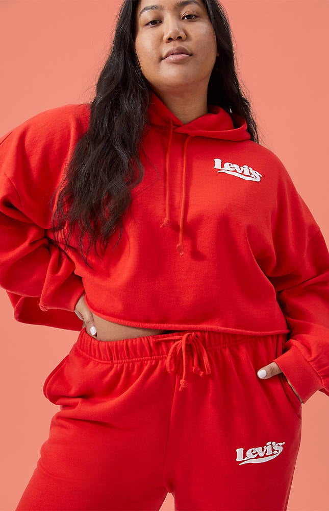 model wearing a red cropped hoodie sweatshirt