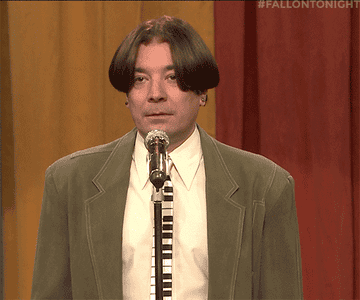Jimmy Fallon stares at Andy Samberg, in the audience, as he sings on stage in a sketch on the Tonight Show