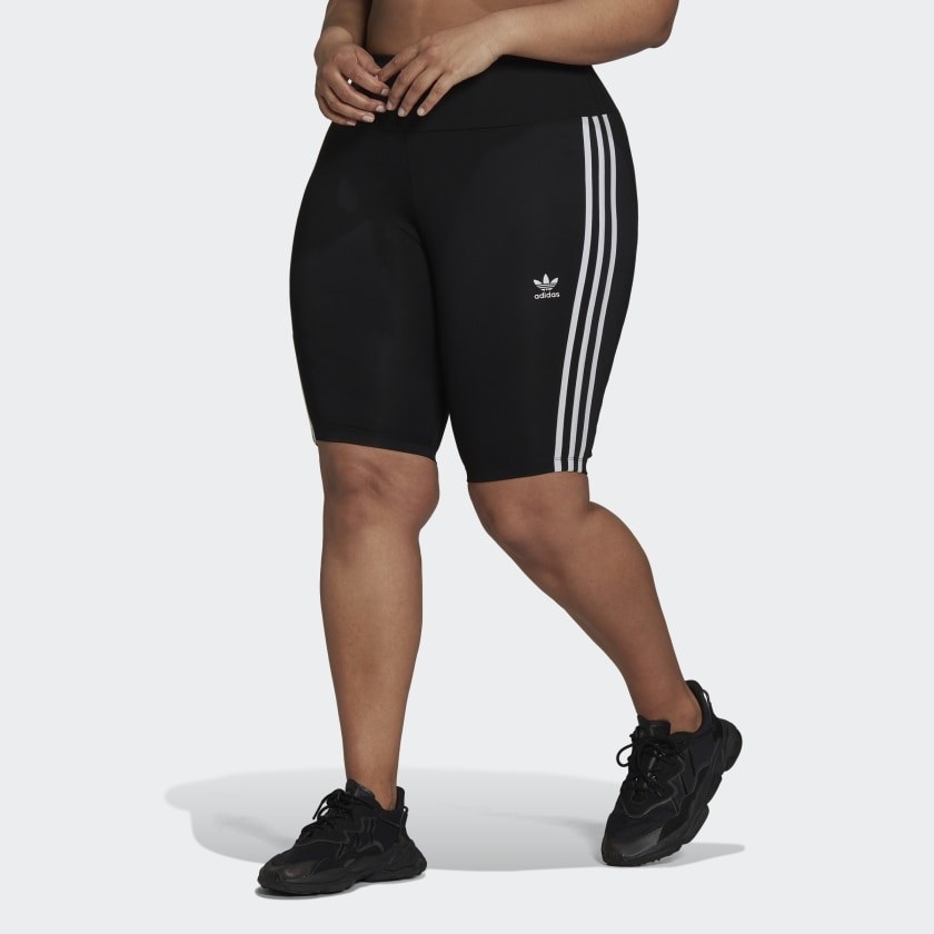 a model wearing the shorts in black with three white stripes on the side