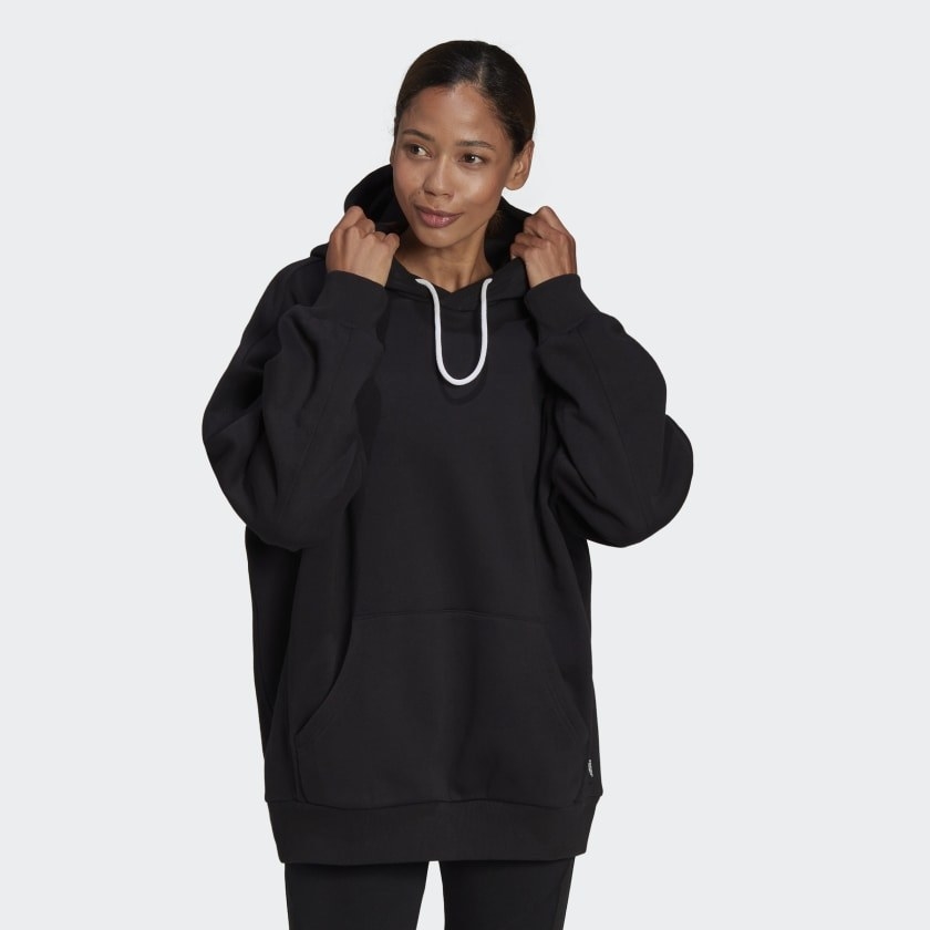 the model wearing the black hoodies with a white infinity drawstring