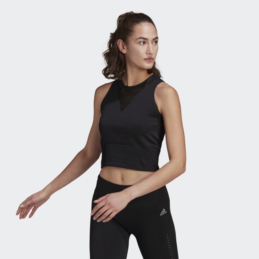 the mode wearing the cropped tank in black