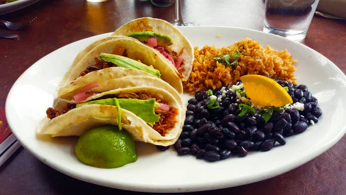 Pork and avocado tacos with black beans and rice.