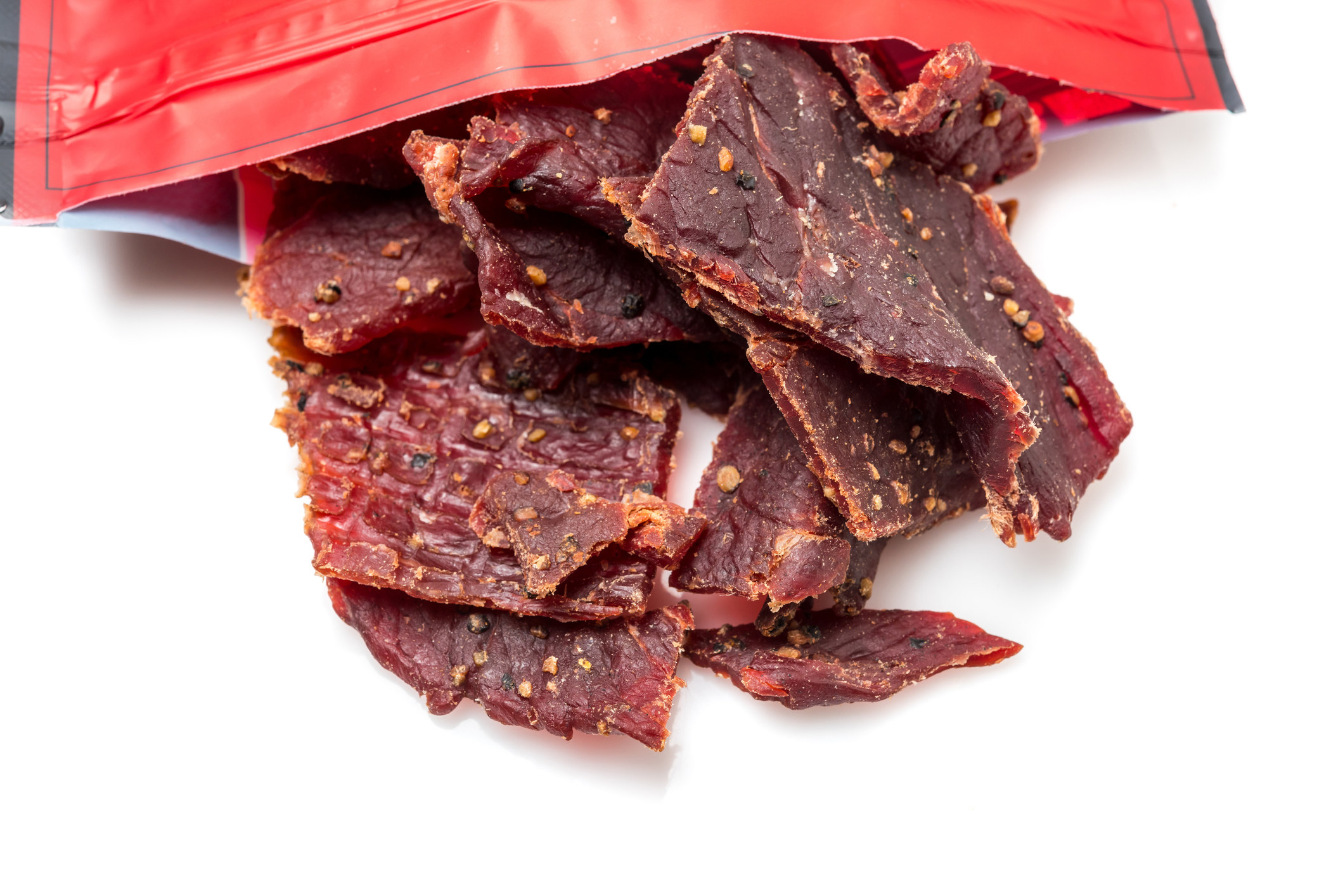 Beef Jerky close up coming out of a bag.