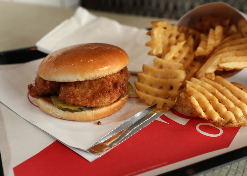 A chicken sandwich with waffle fries.