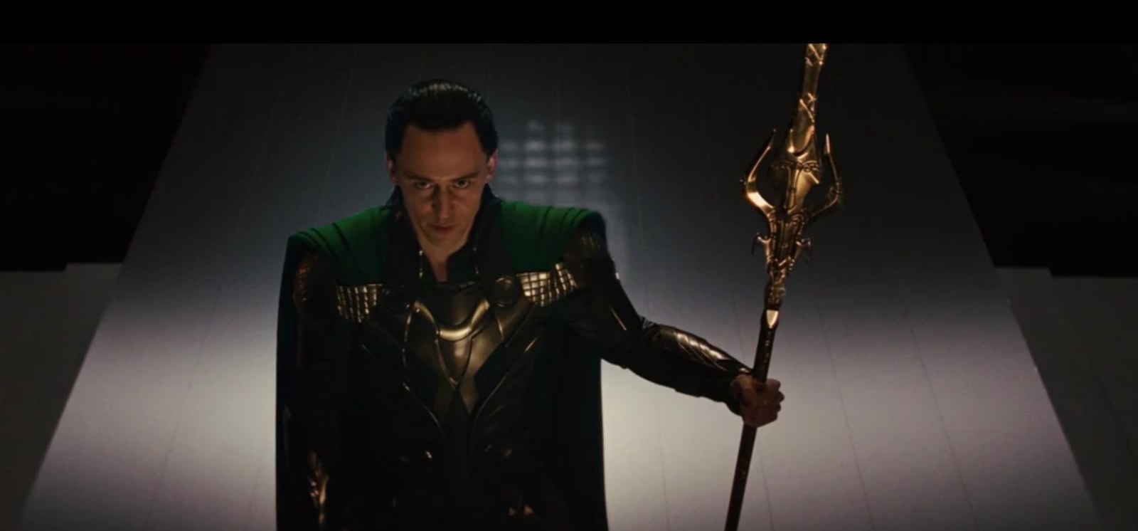 loki stands with his staff in hand