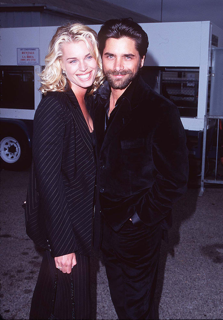 John Stams smiling with Rebecca Romijn as they pose for a picture