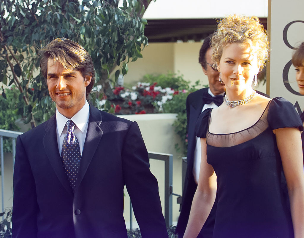 nicole holding hands with Tom Cruise as they walk a red carpet