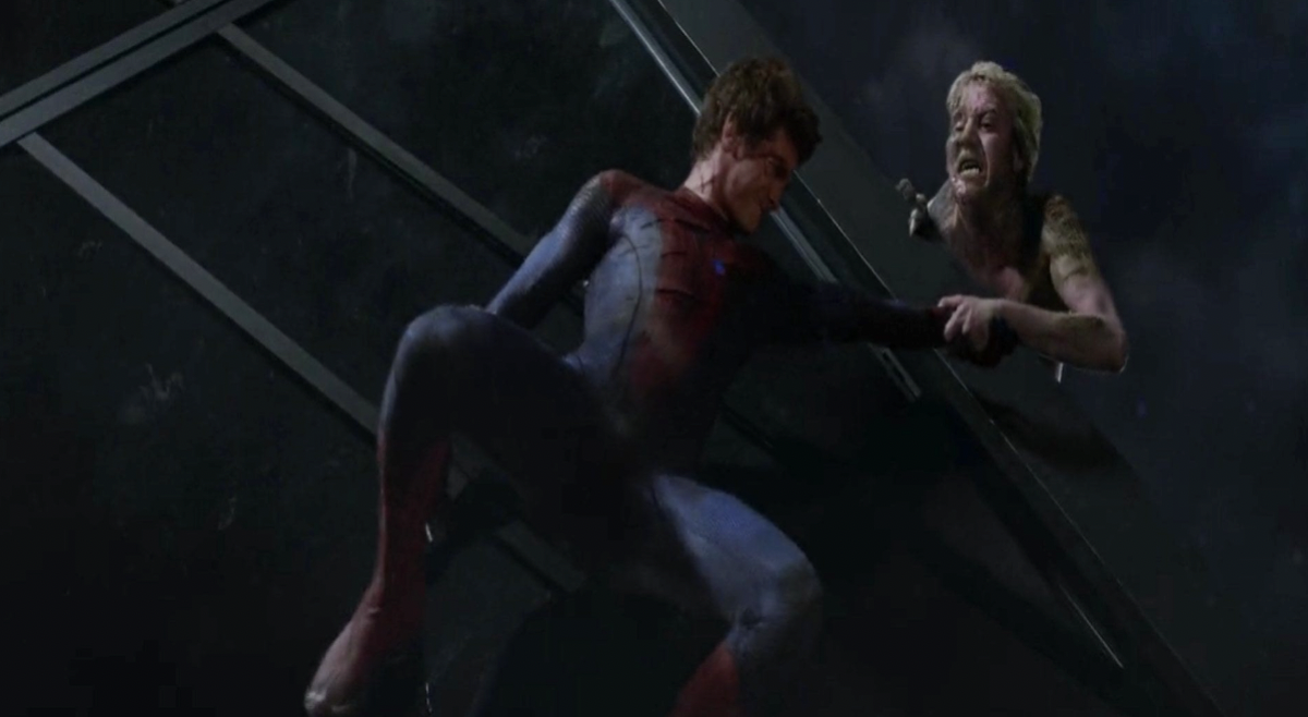 Dr Curt Connors holds Spider-Man&#x27;s hand in order to prevent the latter from falling to his death