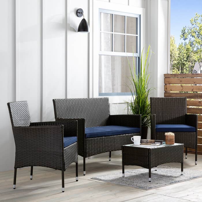 The four-piece set in brown with navy cushions