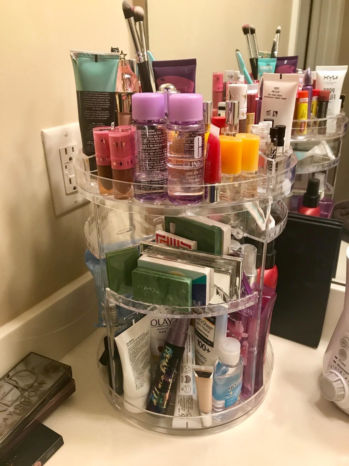 a reviewer's rotating organizer full of cosmetics