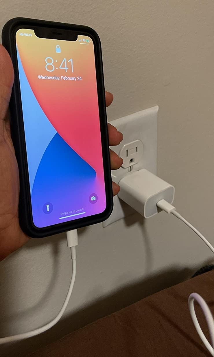 reviewer image of reviewer charging iPhone with charger