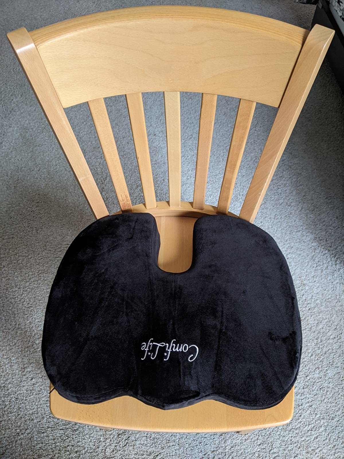 reviewer image of the black seat cushion on a wooden chair