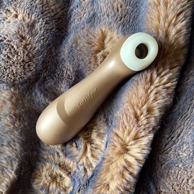 Gold suction vibrator on blanket