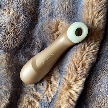 Gold suction vibrator on blanket